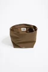 Bolso bandolera de tamaño pequeño confeccionado en nylon, con estructura blanda y cierre de cremallera. Cuenta con asa larga regulable de tejido y logo de la marca aplicado en la parte inferior frontal.