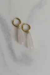 Par de aros tipo argolla con dije colgante en forma de gota de piedra natural color rosado. Realizados en acero quirúrgico dorado.