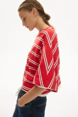Top oversize confeccionado en suave punto de algodón, con diseño a rayas horizontales rojas y blancas, cuello redondo ribeteado y mangas murciélago de largo al codo.