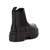 Botas Chelsea de cuero sintético negro con elásticos laterales, suela de plataforma y costuras naranjas.