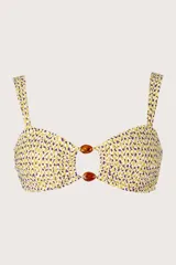Top de bikini bandeau con estampado floral en tonos amarillo y lila, con detalle de cuentas marrones en el centro. Breteles anchos y ajustables.