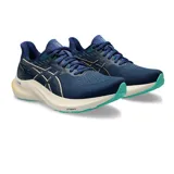 Championes de running Asics GT-2000 12 para mujer, color azul marino con entresuela blanca, detalles en dorado y suela verde turquesa. Confeccionados en tejido de malla transpirable, incorporan tecnología FF Blast+ y PureGel para mayor amortiguación.