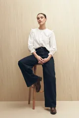 Jean ancho de tiro alto, color azul oscuro, con costuras contrastantes.