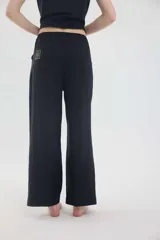 Pantalón de lino color beige, de silueta relajada, tiro medio-alto, cintura elastizada con cordón ajustable, bolsillos laterales y bolsillos traseros.