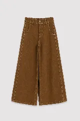 Pantalón de jean color naranja con tiro medio, diseño de pierna ancha y cinco bolsillos. Presenta costuras con pespuntes a contratono.