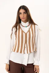 Chaleco tejido a rayas beige y blanco, con escote en V y cierre con ganchitos.
