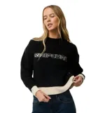 Buzo tejido de punto Rip Curl Archive modelo Script Knit, color negro con detalles en color crudo en el cuello, puños y dobladillo inferior. Presenta el nombre de la marca bordado en el pecho.