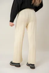 Pantalón de tejido de punto en color azul grisáceo, de corte recto y tiro alto, con detalle de costuras verticales que estilizan la silueta.