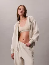 Jogger de felpa de mezcla de algodón en color beige, con cintura elástica, bolsillos laterales, puños en los tobillos y monograma CK estampado en la pierna izquierda.
