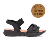Sandalias bajas de cuero negro con ajuste de velcro y elástico.