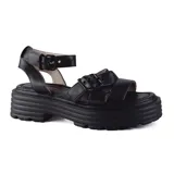 Sandalias negras de cuero con plataforma track y tiras anchas con hebillas ajustables.