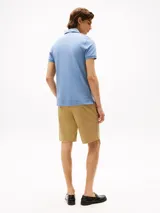 Chomba celeste de corte slim fit, con cuello clásico, tapeta de dos botones y logo de la marca bordado en el pecho.