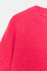 Jersey de punto color vino tinto, de cuello redondo y manga larga, con acabado acanalado (rib) en puños, cuello y bajo.