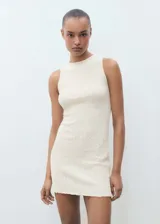 Vestido corto color crema, de tejido texturizado, sin mangas y cuello redondo.