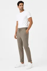 Pantalón de viscosa color marrón topo, de corte slim fit, con cintura elástica con cordón de ajuste y bolsillos laterales.