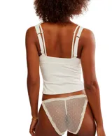 Bombacha tipo tanga de encaje transparente con diseño de lunares, presenta elásticos laterales ajustables y detalles de puntilla en los bordes.