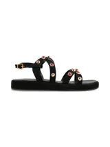 Sandalias negras con plataforma, tiras con apliques de tachas doradas y piedras rojas.