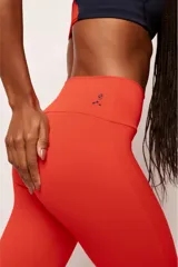 Calza deportiva larga de tiro alto en color rojo, confeccionada en poliamida de alta performance con cintura ancha de sustentación firme y diseño sin costura frontal.