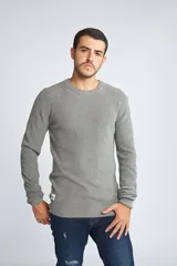 Sweater de punto color mostaza, con cuello redondo y mangas largas.