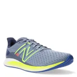 Championes de running New Balance modelo DynaSoft Lowky RC, color gris con detalles en amarillo neón y azul. Presentan capellada de malla transpirable, logo N lateral en contraste y entresuela con tecnología DynaSoft para mayor amortiguación.