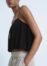 Top negro sin mangas, estilo crop, con tirantes finos ajustables y diseño fruncido que le da un efecto globo.