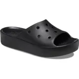 Sandalias Crocs modelo Classic Platform Slide, color negro, con diseño de plataforma alta, tira superior con perforaciones para dijes Jibbitz y plantilla cómoda.