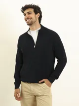 Cardigan azul de punto con cierre de cremallera, cuello alto y bolsillos laterales.