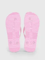 Ojotas de playa rosadas marca Calvin Klein Jeans, con logo estampado en la tira.