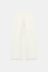 Jeans de tiro medio con diseño wide leg y pernera ancha, estilo de cinco bolsillos, cierre frontal con cremallera y botón metálico.