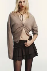 Falda pantalón de tiro medio con diseño de volantes en el ruedo y cierre lateral oculto.