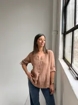 Blusa de lino color camel, con escote en V y botones frontales, de manga 3/4 con tiras ajustables en los puños y diseño holgado.