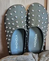 Zuecos negros de cuero vegano con tachas plateadas.