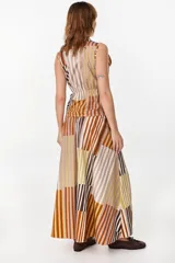 Falda midi de algodón, con diseño geométrico de paneles con rayas verticales en tonos marrón, celeste, blanco y negro. Presenta pretina elastizada en la parte trasera y silueta evasé.