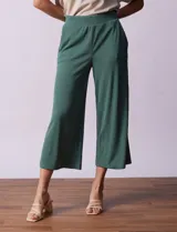 Pantalón capri plisado color beige, marca Dictionary, con pretina ancha elastizada y bolsillos delanteros.