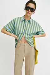 Pantalón de tiro medio con diseño barrel, pernera holgada que se estrecha hacia el tobillo y detalle de raya planchada en el frente y la espalda. Cuenta con cinco bolsillos y cierre frontal con cremallera y botón.