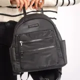 Mochila Korium Ami color gris oscuro con dos bolsillos frontales con cierre y logo de la marca en el frente.