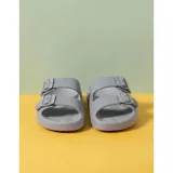 Sandalias chancletas de goma color beige con diseño texturizado en la suela, doble tira ajustable con hebillas y estilo slip-on.