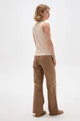 Musculosa de algodón negra con cuello redondo y breteles anchos, diseño ajustado al cuerpo y detalle de botones en el lateral con dobladillo asimétrico.