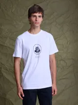 Remera blanca de algodón con cuello redondo, manga corta y estampa central pequeña en color negro que representa un lince con parche pirata.