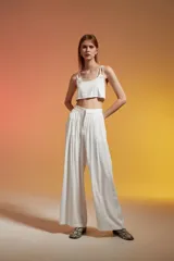 Top corto color crudo, con breteles finos y escote redondo.