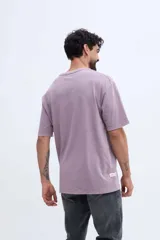 Remera oversize de manga larga color gris con efecto lavado y estampa botánica en el pecho.