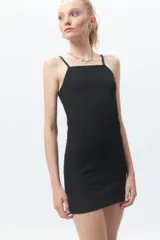 Vestido corto negro, ajustado al cuerpo, sin mangas y con escote cuadrado. La tela presenta una textura tramada o con relieve.