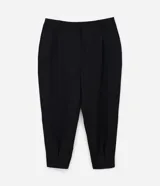Pantalón de sastrería corte carrot, color negro, con cintura alta, pliegues delanteros, bolsillos laterales y elástico en la parte posterior de la cintura.
