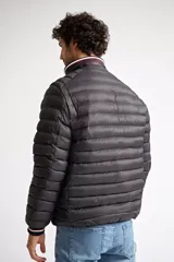 Campera puffer de nylon color azul marino, con cierre frontal completo, cuello alto y puños con detalle de rayas. Cuenta con bolsillos laterales con cierre y logo estampado en el pecho.