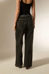 Pantalon de jean recto de tiro alto, con acabado metalizado en color gris oscuro. Presenta bolsillos laterales y traseros, con cierre de botón y cremallera.