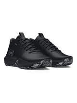 Championes Under Armour Lockdown 7 de color negro, diseñados para básquetbol. Presentan una parte superior de malla transpirable con superposiciones de cuero y película, entresuela de EVA y suela de caucho macizo con un patrón de tracción en blanco y negro. Incluyen el logo de la marca en el lateral.