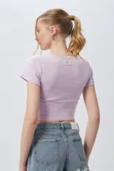 Top corto negro ajustado al cuerpo, de manga corta y cuello redondo.