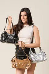 Cartera tipo baguette de ecocuero brillante, con cierre frontal y dos correas intercambiables.