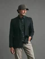 Saco sport de corte clásico, con cuello de solapa, cierre frontal de dos botones y bolsillos de ribete laterales.