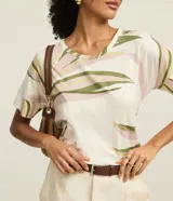 Blusa estilo remera confeccionada con viscosa certificada. La prenda tiene cuello redondo, mangas cortas y estampa de follajes.